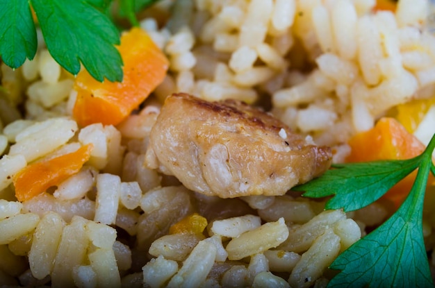 Photo pilaf from rice pork carrots and spices close-up
