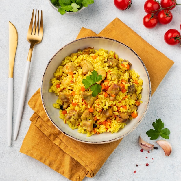 Pilaf with chicken on a plate on a white background