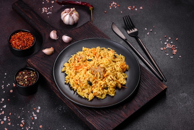 Pilaf with chicken Traditional oriental hot dish of boiled rice chicken meat vegetables and spices in a plate