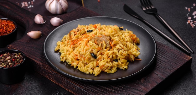 Pilaf with chicken Traditional oriental hot dish of boiled rice chicken meat vegetables and spices in a plate