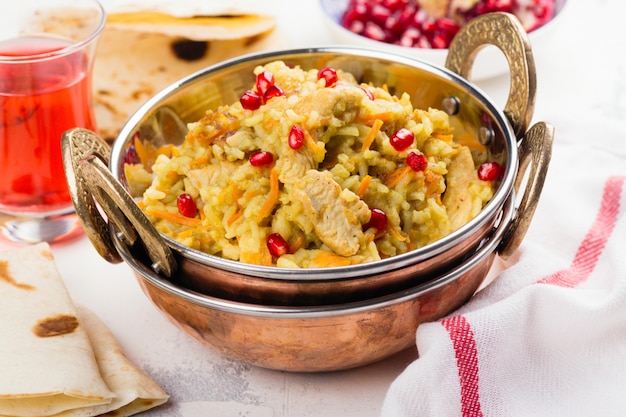 Pilaf with meat, spices and pomegranate seeds. 