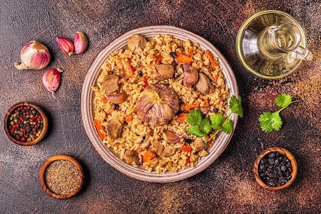 Pilaf with meat, vegetables and spices, top view.