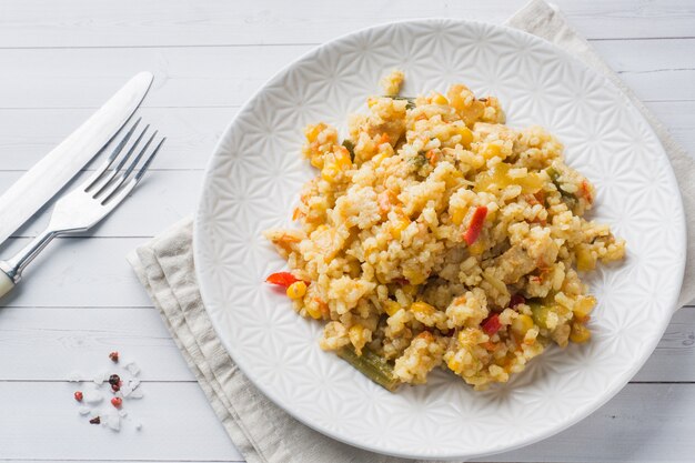 Pilaf with vegetables and chicken in a gray plate