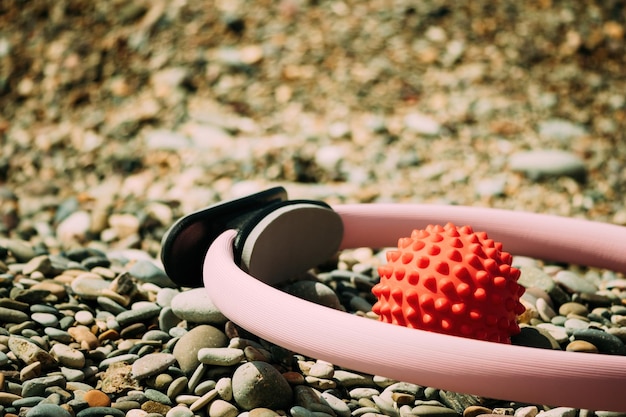 Pilates magic ring and rubber band on yoga mat near sea female fitness yoga concept healthy