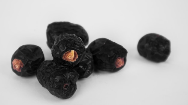 A pile of ajwa dates in a white background