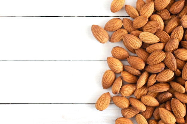 Pile of almond nuts on wood table,Top view.