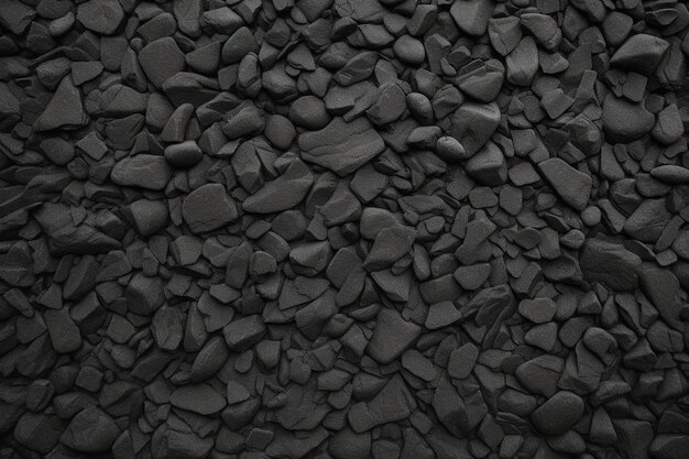 a pile of black pebbles on a black background