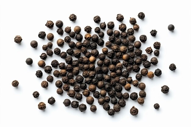 a pile of black pepper seeds on a white surface