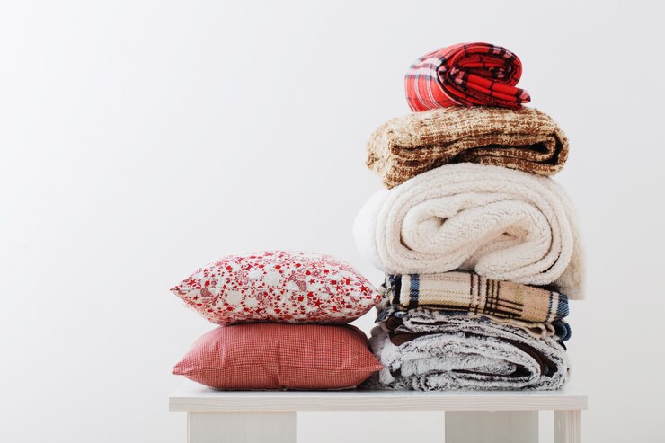 Pile of blankets on a white space