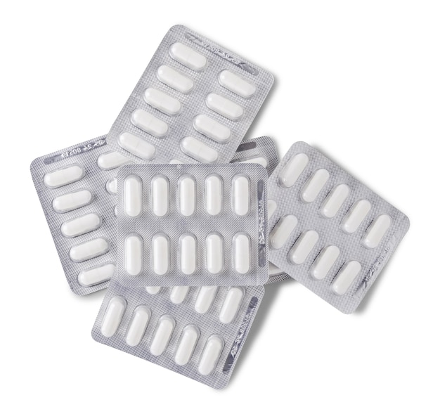 Pile of blisters of white pills isolated on white background