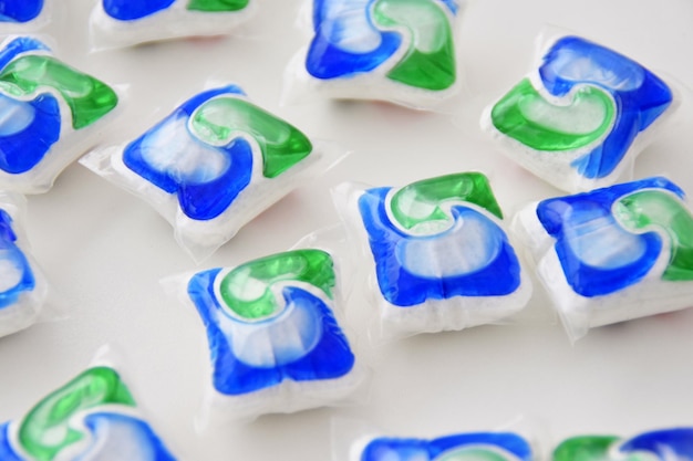 A pile of blue and green spinach soap on a white surface