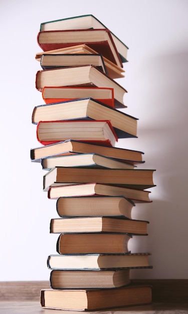 Pile of books on wall background