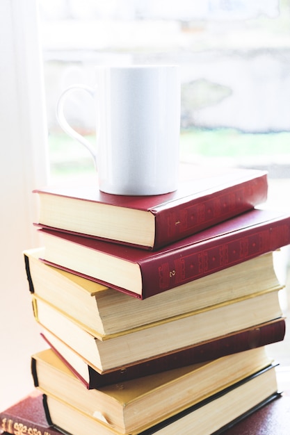 Pile of books and white cup