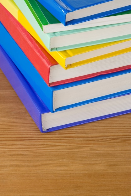 Pile of books at wood table board