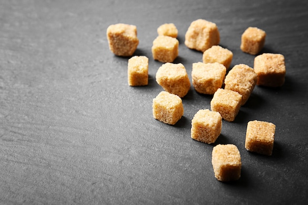 Pile of brown sugar cubes on the table