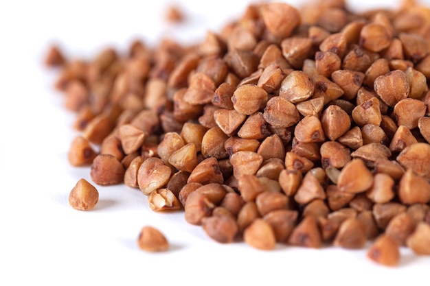 Pile of buckwheat seeds isolated on white background closeup