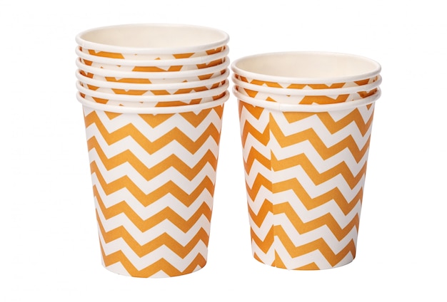 Pile of cardboard cups with beige geometric pattern isolated on white background