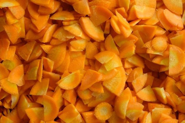 pile of carrot slices. Carrots are biennial plants that store large amounts of carbohydrates. Daucus