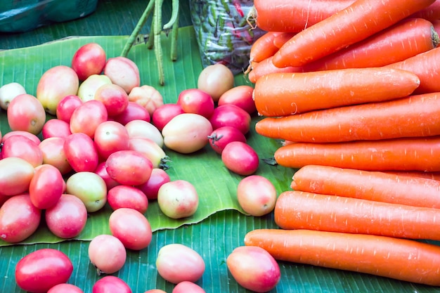 A pile of carrots and cherry tomatoes