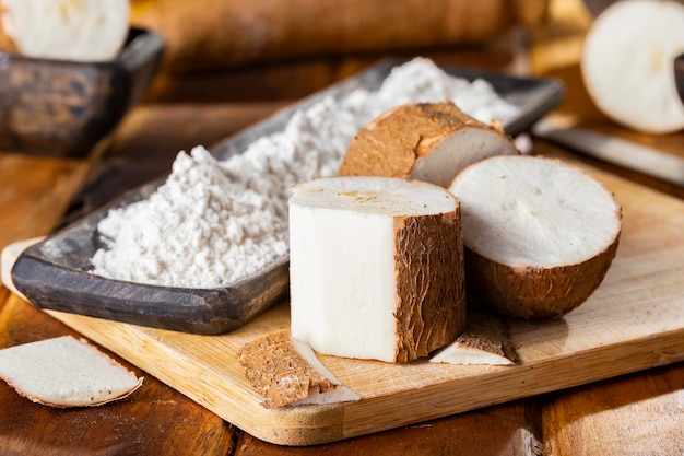 Pile of cassava cassava and cassava flour on a background of rustic wood Manihot esculenta