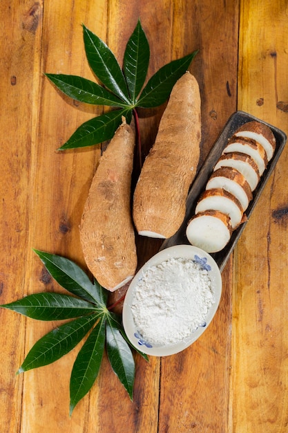 Pile of cassava cassava and cassava flour on a background of rustic wood Manihot esculenta