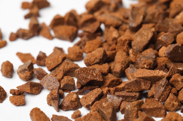 Pile of chicory granules on white background closeup