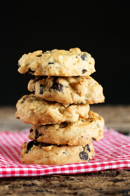 Pile of chocolate chip cookies on napkin.