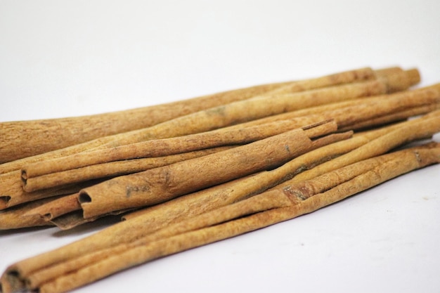 a pile of cinnamon sticks with the word cinnamon on the top.