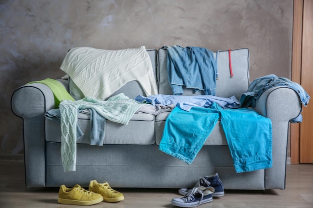 Photo pile of clothes on cozy couch