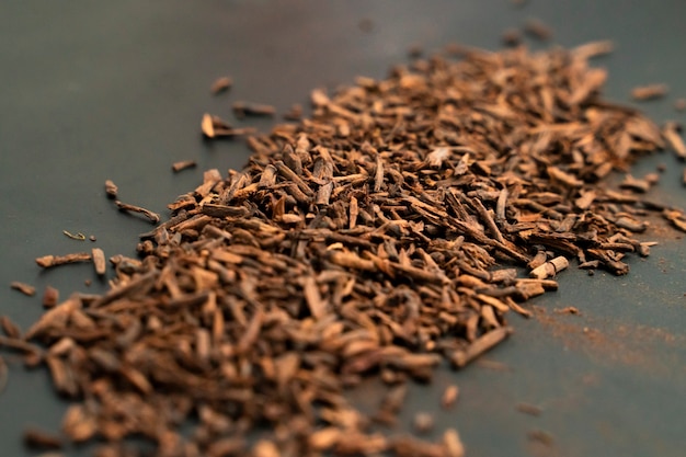 pile of cloves for cigarette flavor close up on a black background