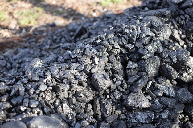 A pile of coal on the lawn. Eco-friendly fuel for residential buildings and fireplaces.