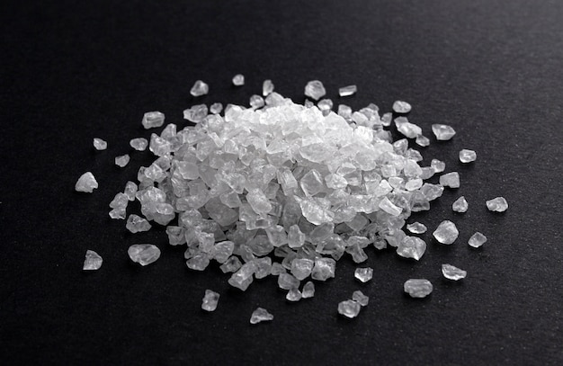 Pile of coarse sea salt on black