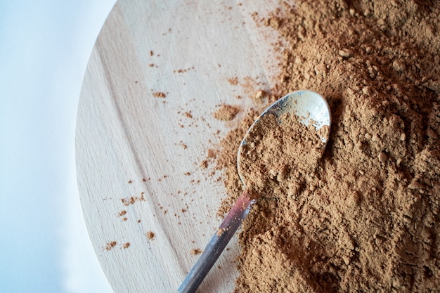 pile cocoa powder isolated on wooden background