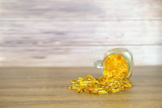 A pile of cod liver oil capsule dietary supplement for health-care concepts.