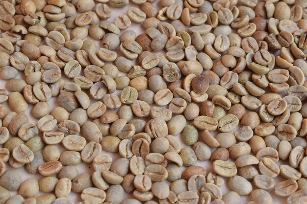 A pile of coffee beans is shown on a table.