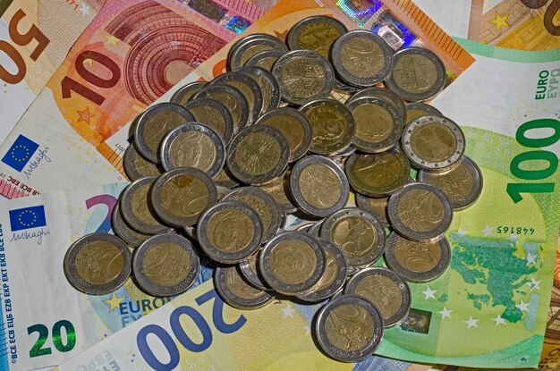 Куча монет над банкнотами евро