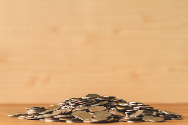 Pile of coins on a wooden table. Financial Concept. Selective focus. Free space for text