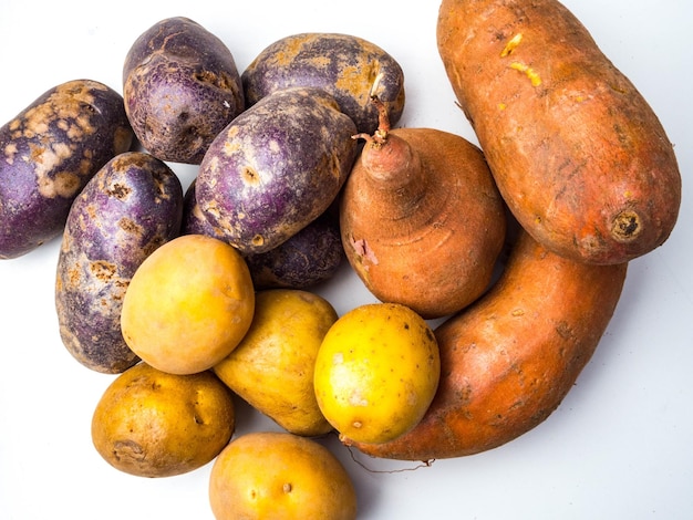 Pile of colorful fresh little potatoes over a white background