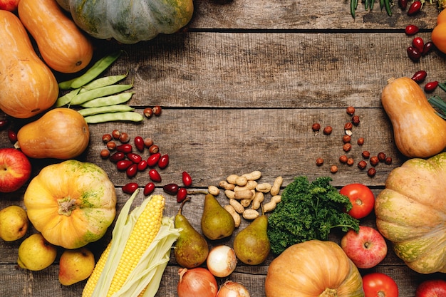 Pile of colorful fruits and vegetables on wooden background