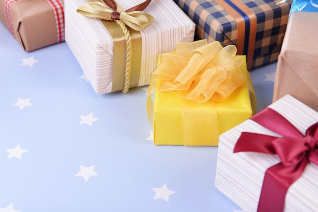 Pile of colorful gifts on blue background with stars