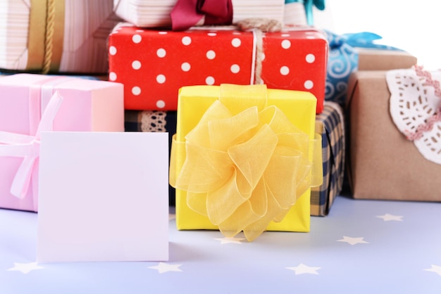 Pile of colorful gifts on blue background with stars