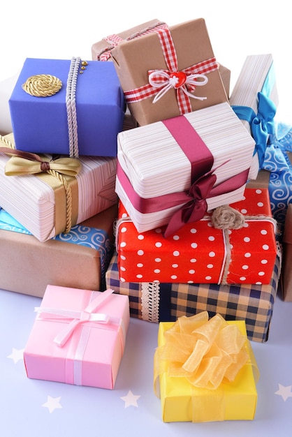 Photo pile of colorful gifts on blue background with stars