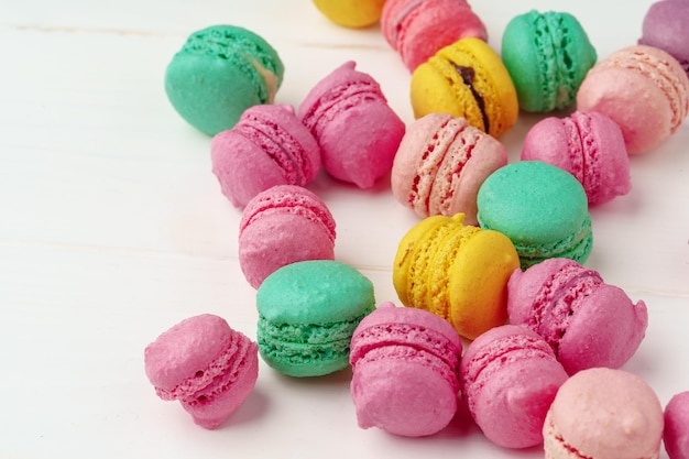 Pile of colorful macarons on white background