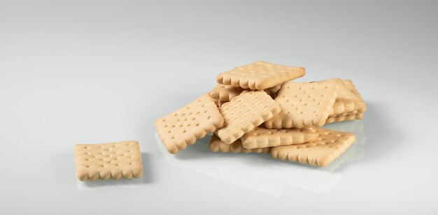 A pile of crackers carelessly scattered on a light background closeup