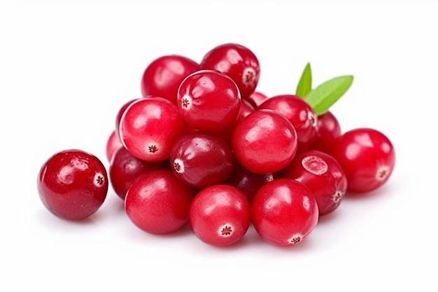 a pile of cranberries with a green leaf on top.