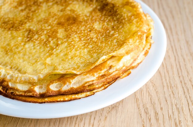 Pile of crepes on the wooden background