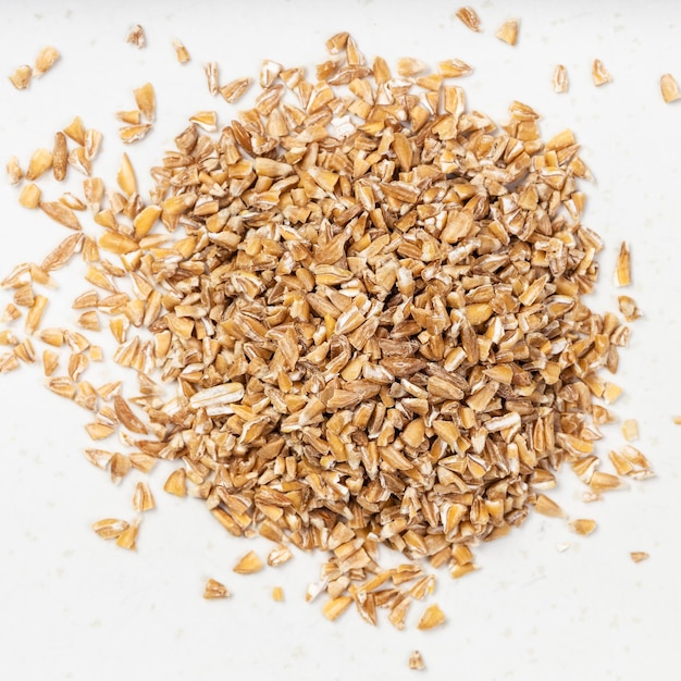 Premium Photo Pile of crushed emmer farro hulled wheat groats