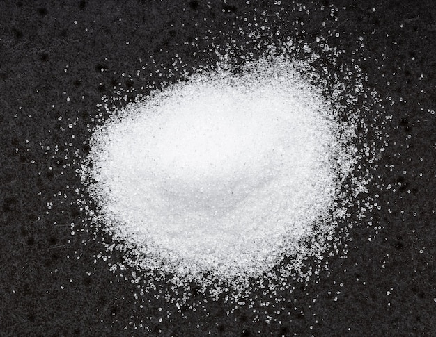 Pile of crystalline erythritol sugar on black