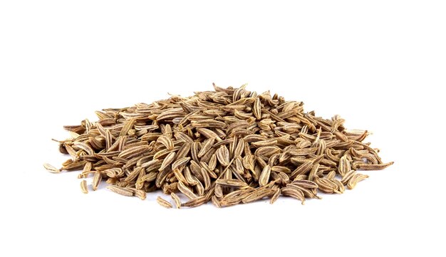 Pile of cumin seeds isolated on white background