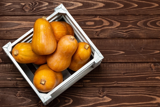 Pile of different pumpkins in a wooden box